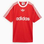 Red Adidas T-shirt with white three stripes on the sleeves and the white trefoil logo on the chest