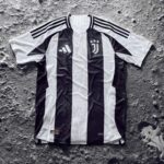 tLZVYqy1SdoMBQh | UAE SPORT STORE Juventus black-and-white striped soccer jersey laid flat on a rough gray surface, with Adidas logo and three shoulder stripes visible.
