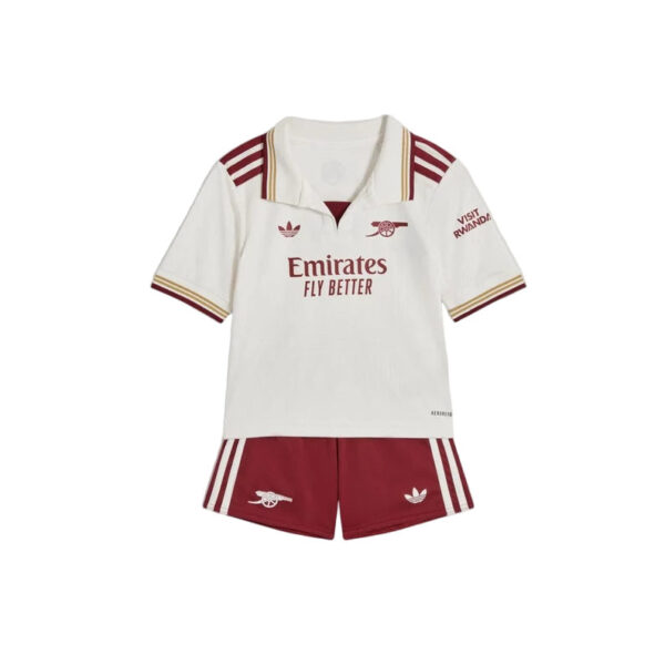 White polo shirt with maroon trim and Emirates Fly Better logo, worn with maroon shorts featuring white stripes and Arsenal crest.