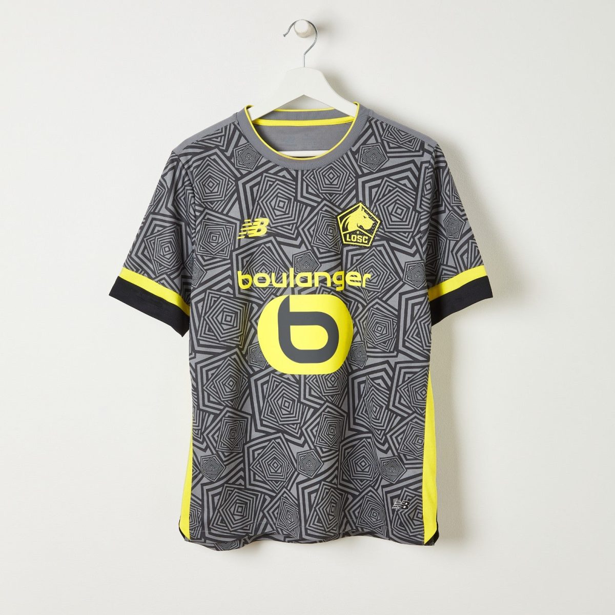 Gray geometric-patterned football jersey on a white hanger with yellow trim and LOSC crest visible on the chest area.