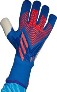 Blue goalkeeper glove with red grip pattern held up palm-forward, showing textured fingers and palm padding