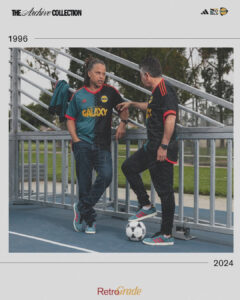 vpeEEpR8l5yUDHO | UAE SPORT STORE Two men in Galaxy soccer jerseys lean on a railing beside a futsal court, with a soccer ball at their feet; a timeline from 1996 to 2024 and The Archive Collection branding are visible above.