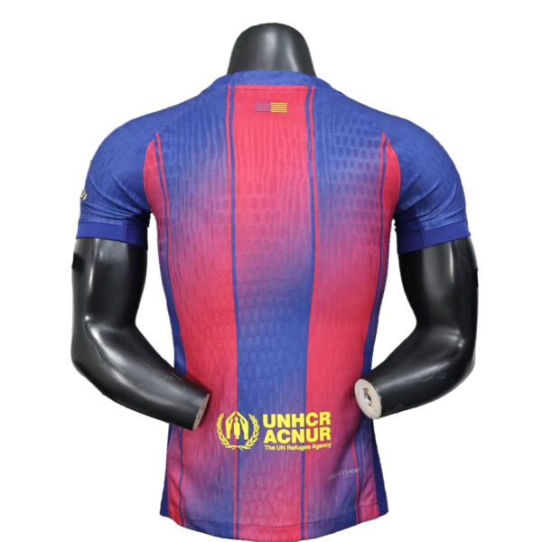 Back view of a blue-to-pink gradient cycling jersey with UNHCR logo on the lower back and a small flag on the neck area.