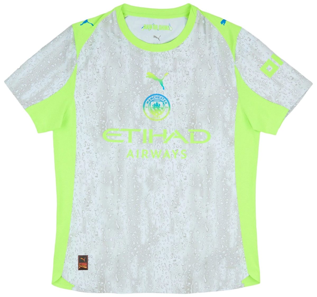 Manchester City football jersey in gray with neon lime panels and water-drop pattern, featuring the club crest and Puma logos on the chest and sleeves and Etihad Airways text partially visible.