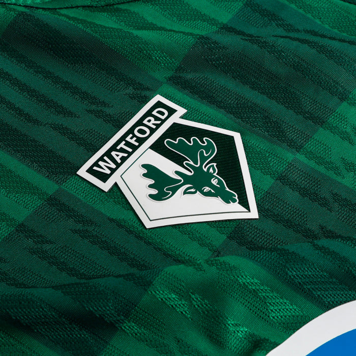 xjy | UAE SPORT STORE Watford FC crest on green fabric, featuring a white shield with a hornet and the word 'WATFORD'.