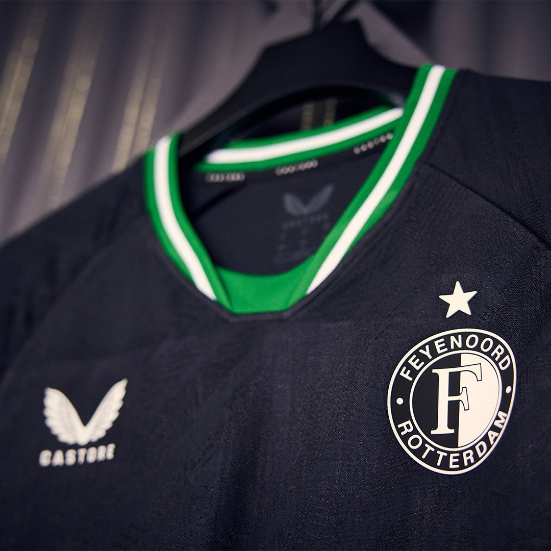 zN2TZsAKSLhJ31r | UAE SPORT STORE Dark soccer jersey on a hanger featuring the Feyenoord Rotterdam crest with a white star above and green-and-white collar trim.