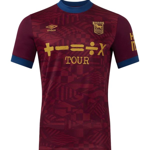 Maroon Ipswich Town tour jersey with blue collar, gold crest and sponsor text, geometric pattern throughout