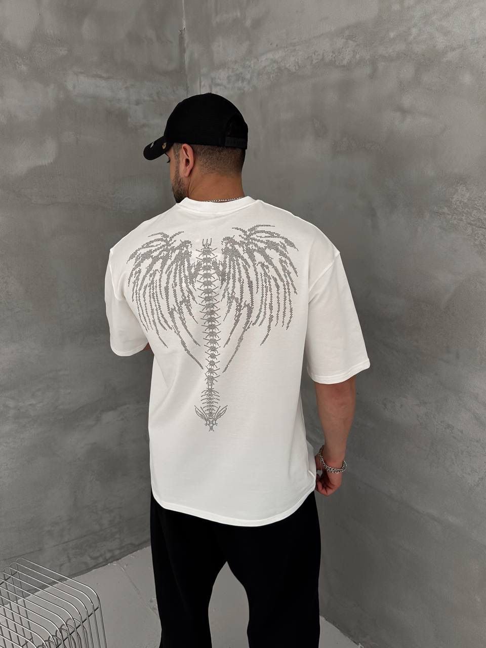 10299483-0175-489d-97b0-52627c524592 | UAE SPORT STORE Men’s White Oversized Dark Angel Rhinestone T-Shirt