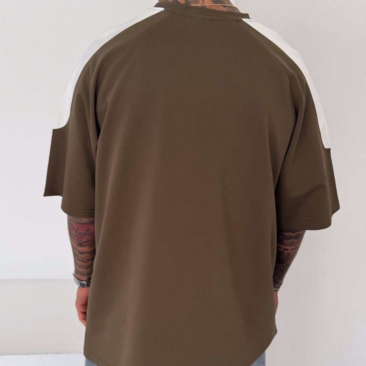 4bf4b49d-dc41-4ffe-afb1-0d85da825b97 | UAE SPORT STORE Men’s Oversized Olive Graphic T-Shirt with White Shoulder Panels