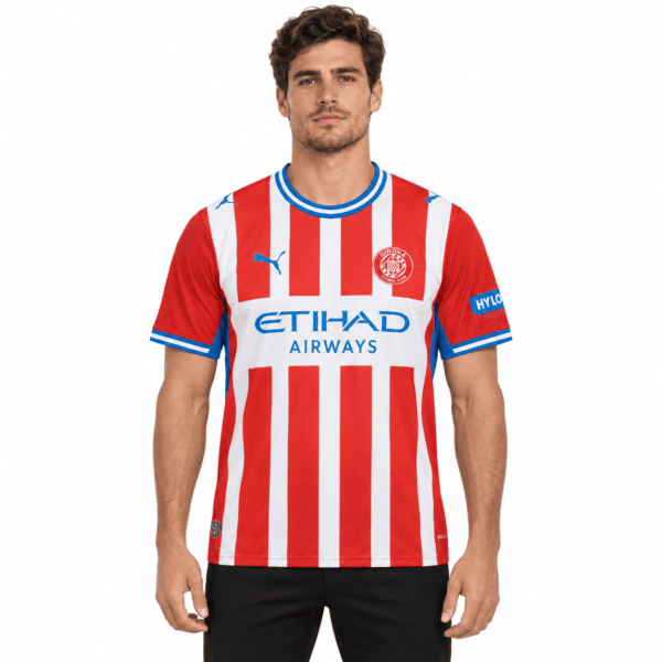 0687d9ed-498a-45e1-9dd9-e29560c99556 - UAE SPORT STORE Girona home football jersey 2026/27 with red and white vertical stripes, blue accents.