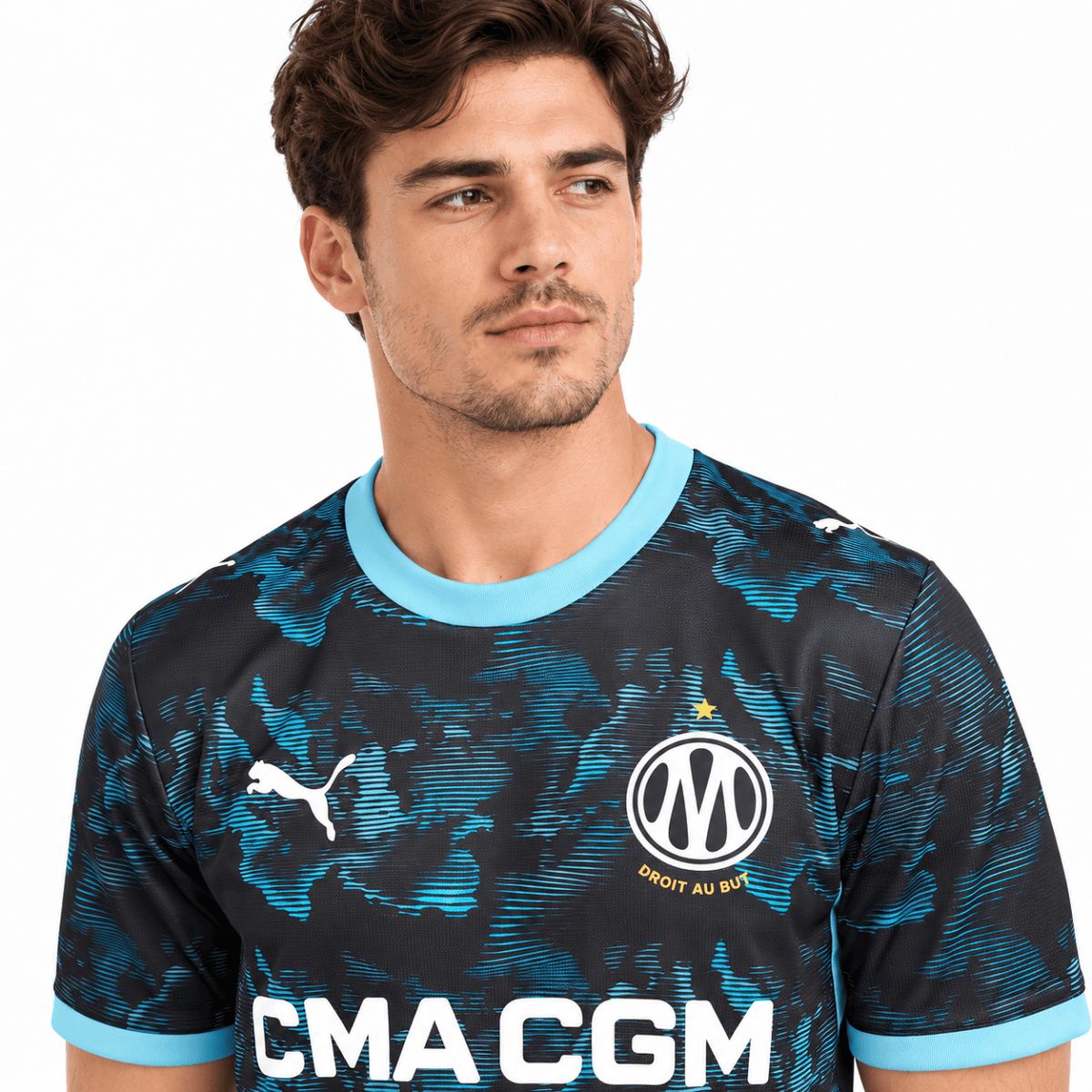 Marseille away jersey 2026/27 with black and blue pattern, club crest, Puma logo, and sponsor.