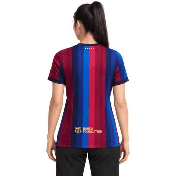 Barcelona Women Home Jersey 2026/27 with red and blue vertical stripes and 'BARCA FOUNDATION' logo.