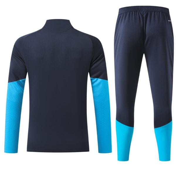 Spain navy training quarter-zip tracksuit with crest and gold logo details.