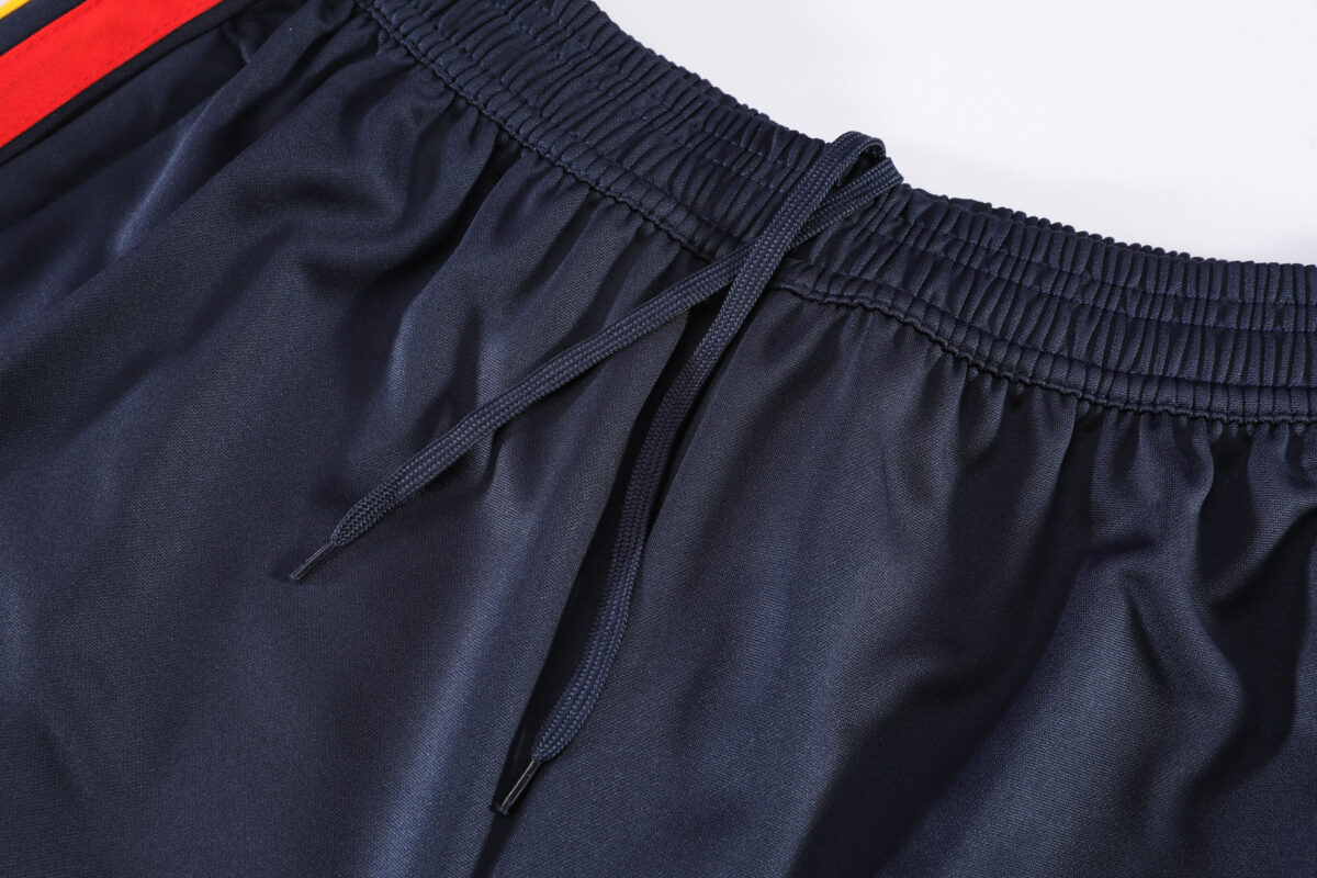 Close-up of navy blue Spain training tracksuit with drawstring waistband.