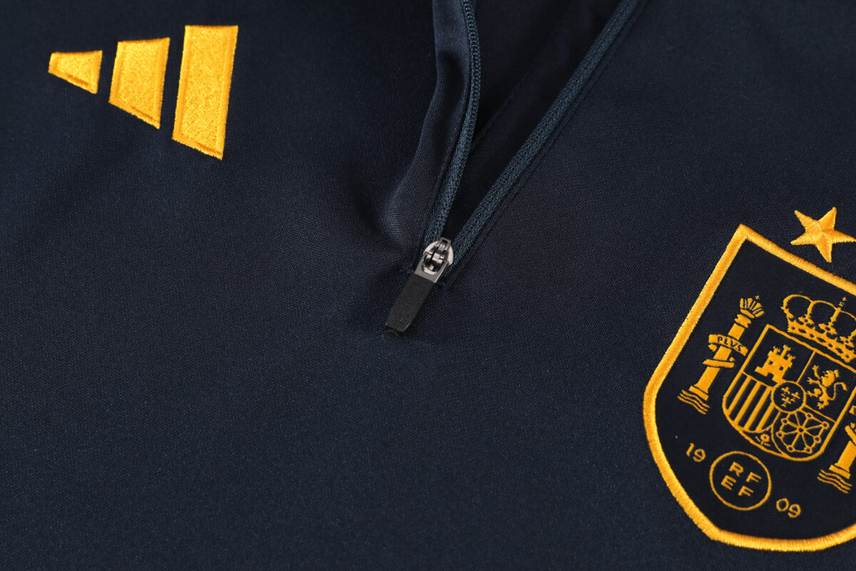 Spain navy training quarter-zip tracksuit with crest and gold logo details.
