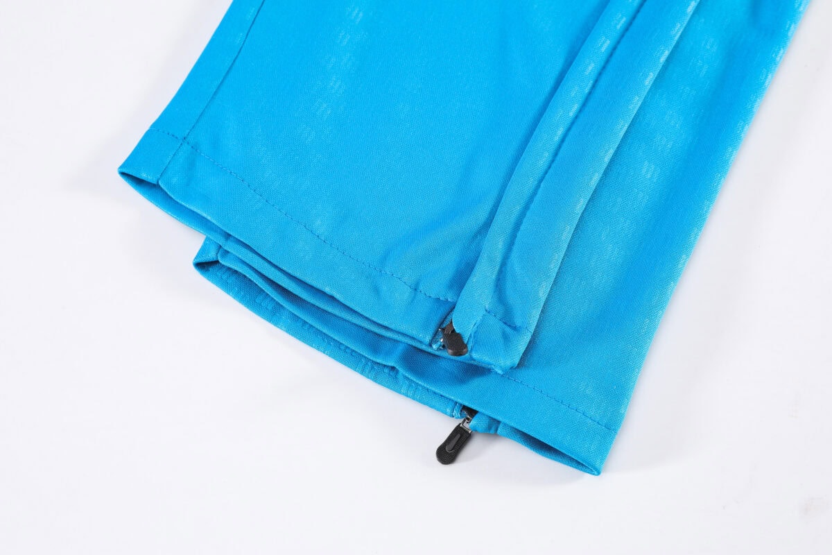 Close-up of a blue training tracksuit with a zipper at the bottom.