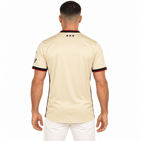 Beige Ipswich Town away jersey with black and red accents, back view.