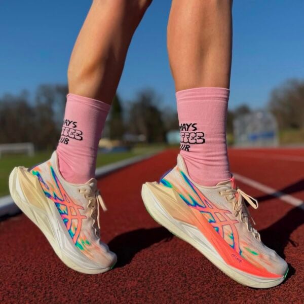 00ee581d-030d-4321-a6fa-2cf6aa38a103jpg - UAE SPORT STORE Person wearing ASICS Superblast 3 Seashell Sun Coral running shoes on track with pink socks.
