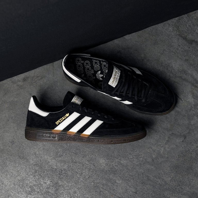 Adidas Handball Spezial Black Gum sneakers on gray surface.