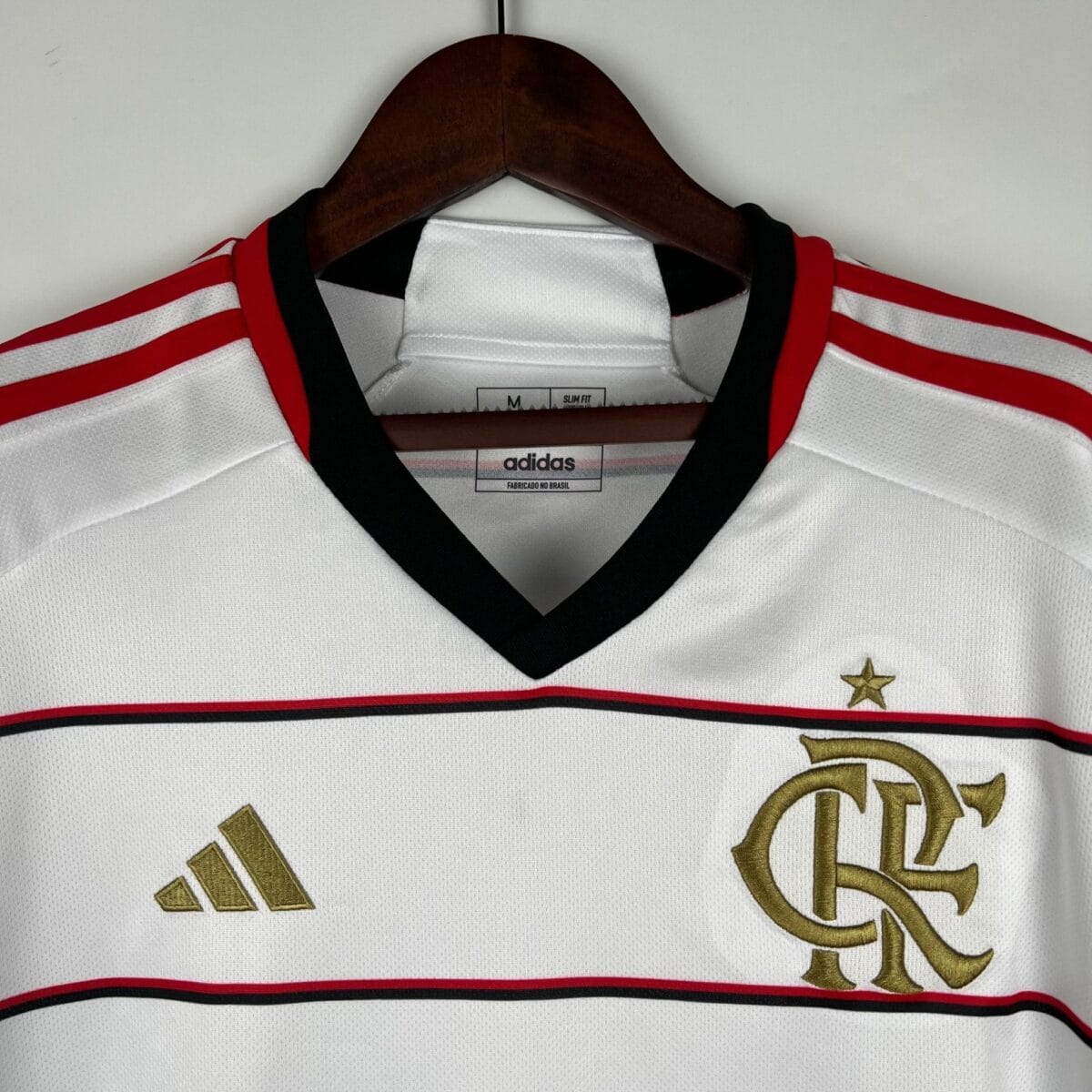 Real Madrid home football jersey with club crest and gold star, white with red and black accents.