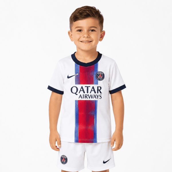 Child wearing PSG away kit for kids 2026/27 with club logo and Qatar Airways sponsor.