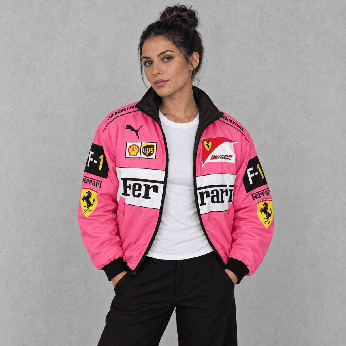 Woman in pink Ferrari Formula 1 team jacket with sponsor logos.