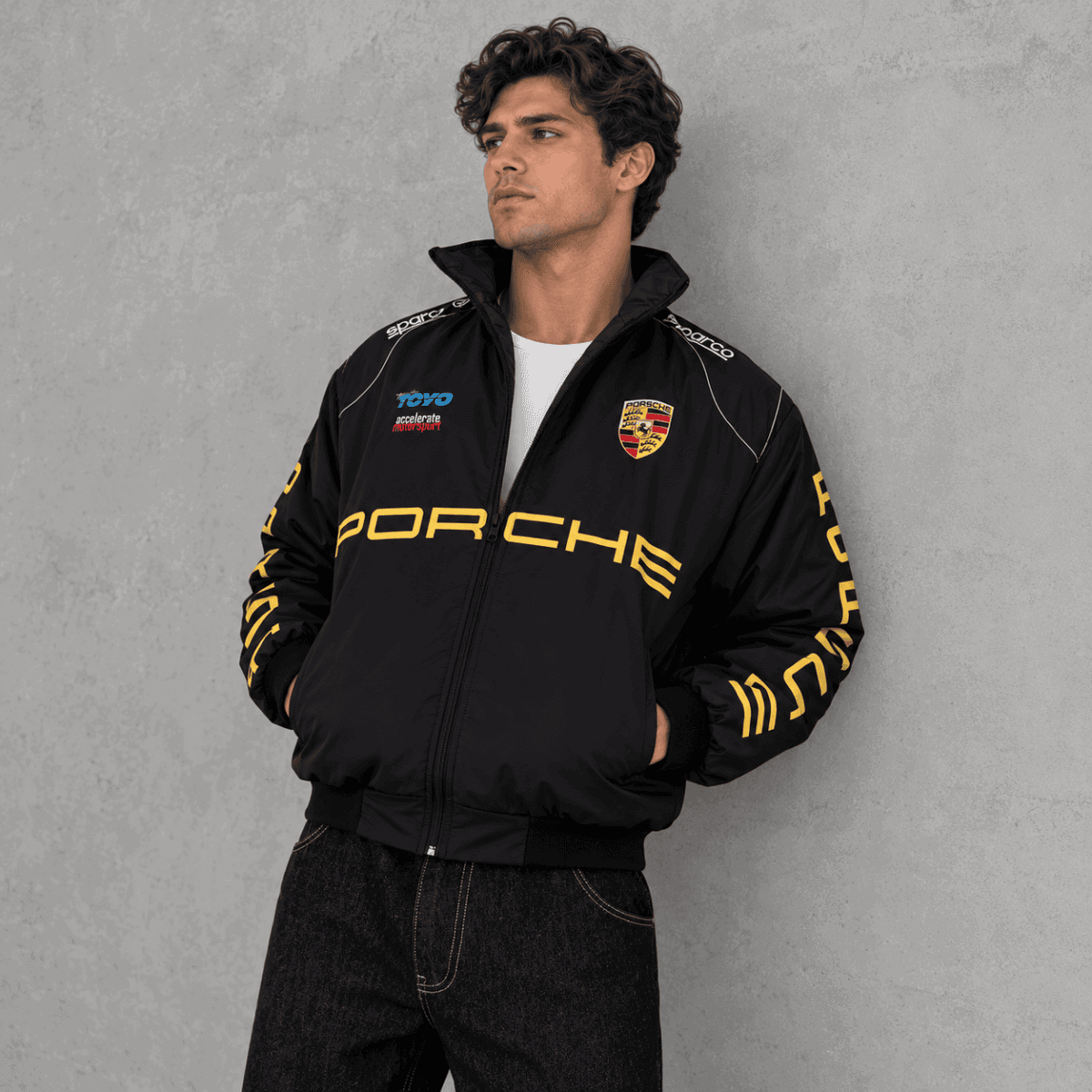 Porsche racing jacket with Porsche logo and sponsor patches, black color.