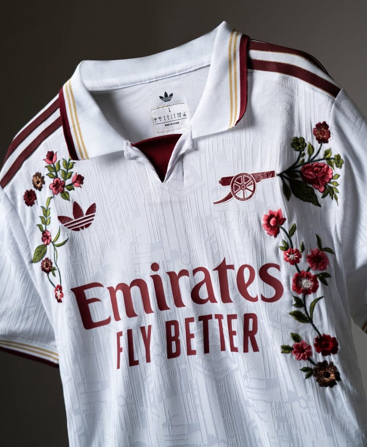 Arsenal football club away kit with floral design and Emirates sponsor logo.