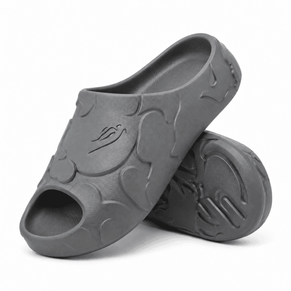 08bcec89-20ec-4ad5-8888-dacf34cc6959 - UAE SPORT STORE Grey Bape Slides with embossed logo and wave design on the surface.
