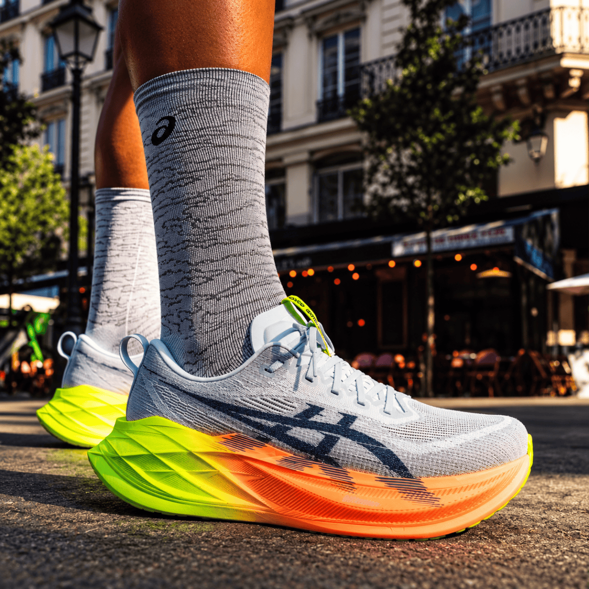 ASICS Superblast 2 Paris running shoes with white, yellow, and orange sole.