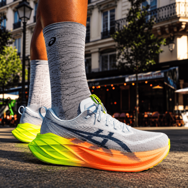 ASICS Superblast 2 Paris running shoes with white, yellow, and orange sole.