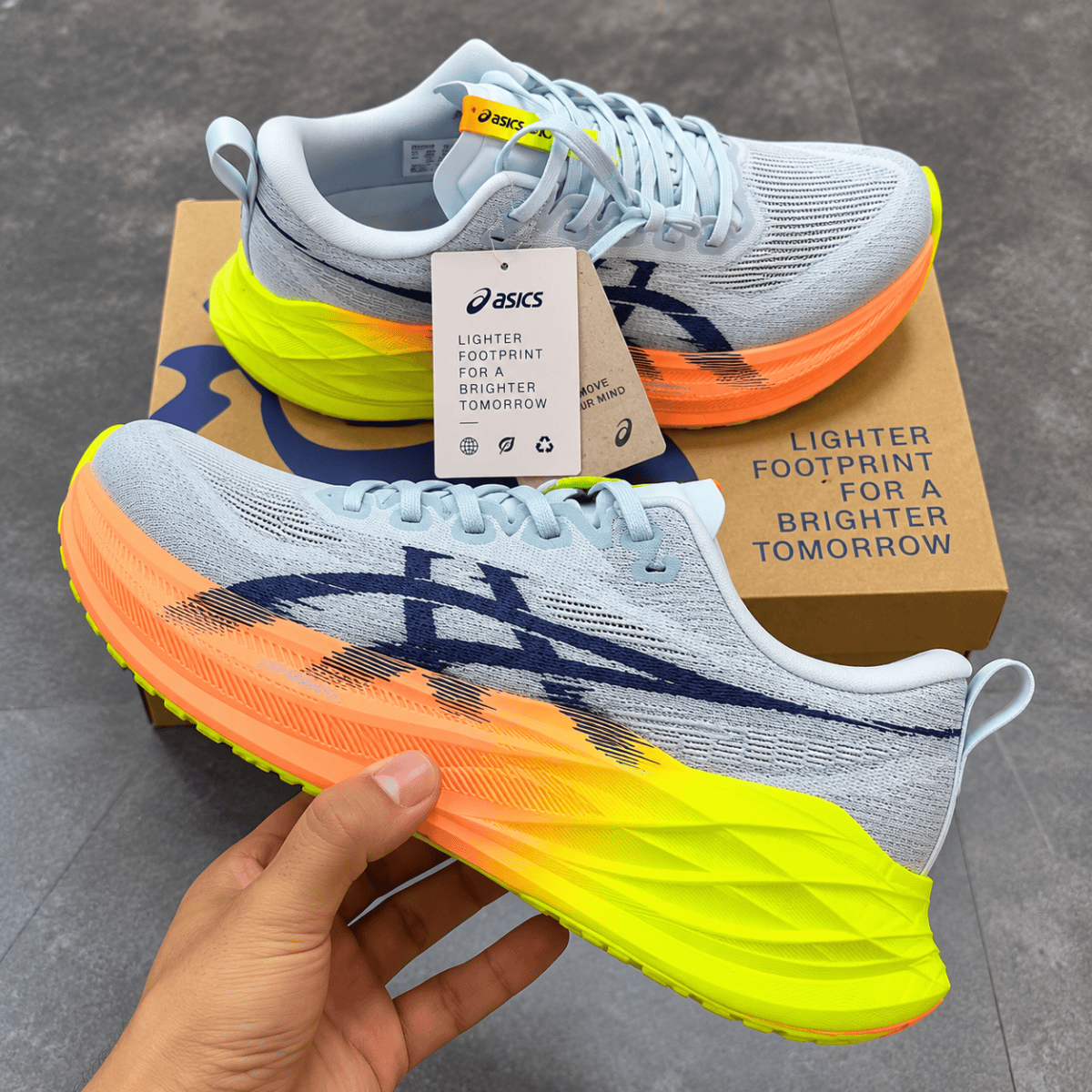 ASICS Superblast 2 Paris running shoes with white, yellow, and orange colors.
