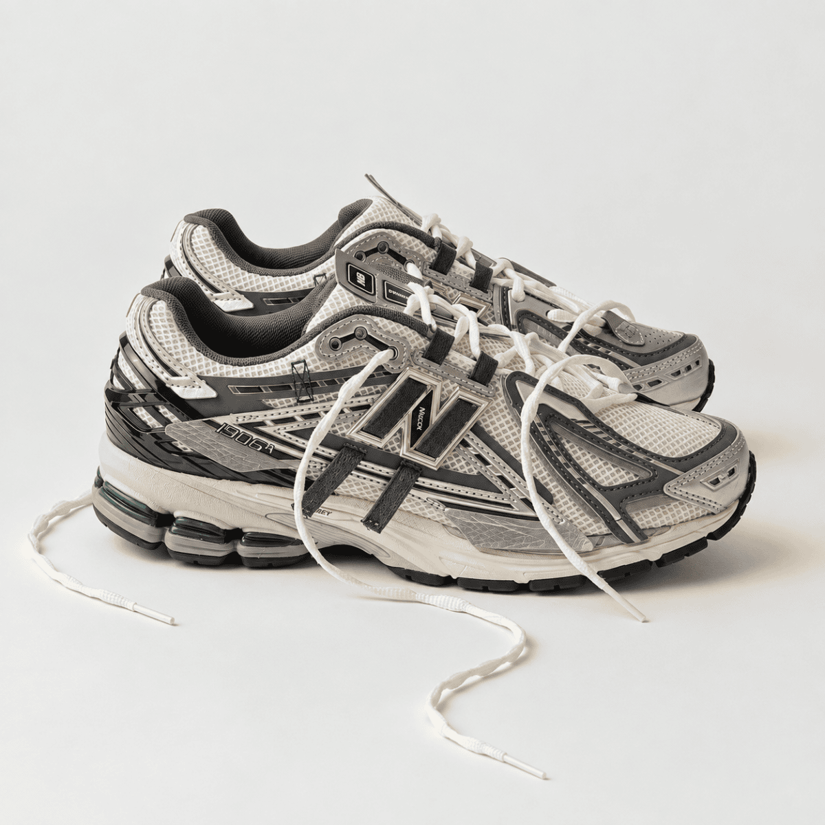New Balance 1906 Mesh-Panel Sneakers in grey and black with white accents.
