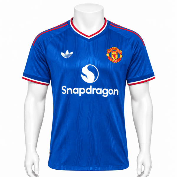 242611a9-0dc7-4e37-86d1-c01a94a8ad78 - UAE SPORT STORE Manchester United away player jersey 2026/27 in blue with red and white accents.