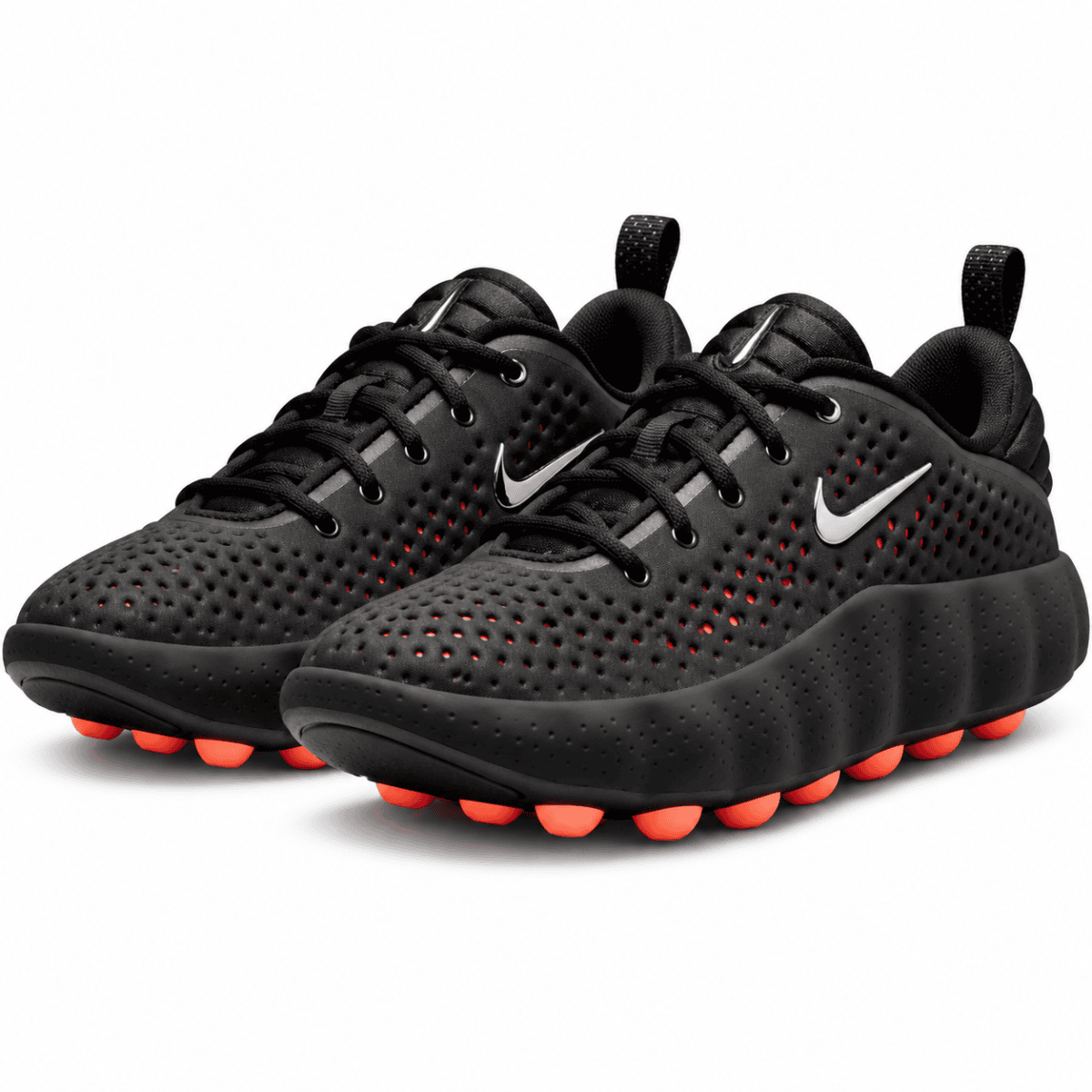 Black Nike running shoes with red accents and perforated upper.
