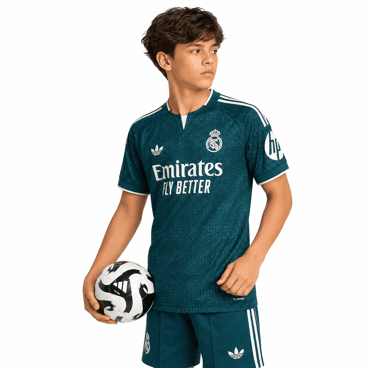 293faa6a-e3dc-4c59-95ca-876d8f874440 - UAE SPORT STORE Real Madrid kids away kit 2026/27 with blue jersey and shorts, boy holding soccer ball.
