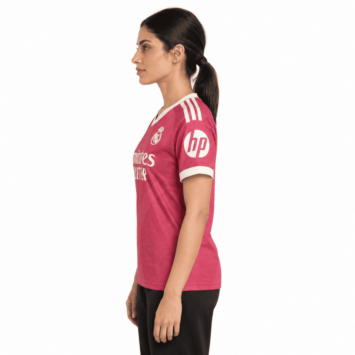 Female athlete in pink football jersey with white accents and sponsor logos.