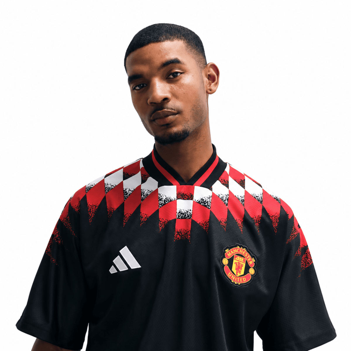 Manchester United lifestyle jersey with black, red, and white geometric pattern.