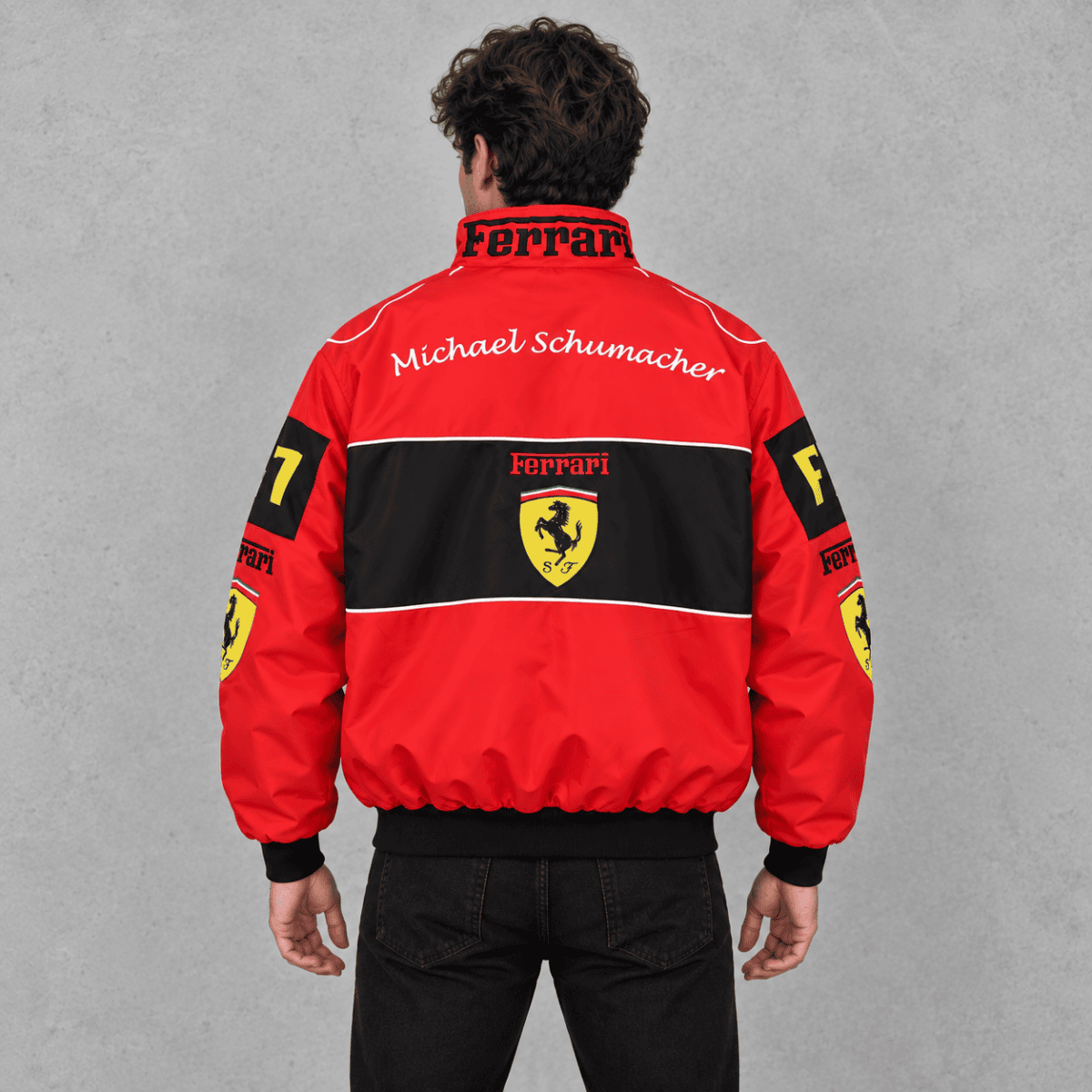 Red Ferrari racing jacket with black and yellow logo and Michael Schumacher signature.