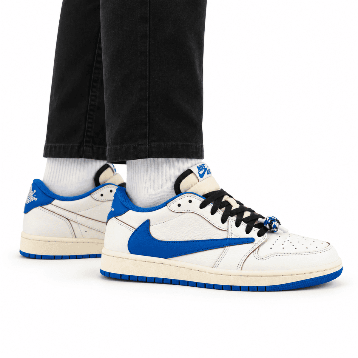 Travis Scott x Fragment x Air Jordan 1 Low OG sneakers in sail and military blue colors.