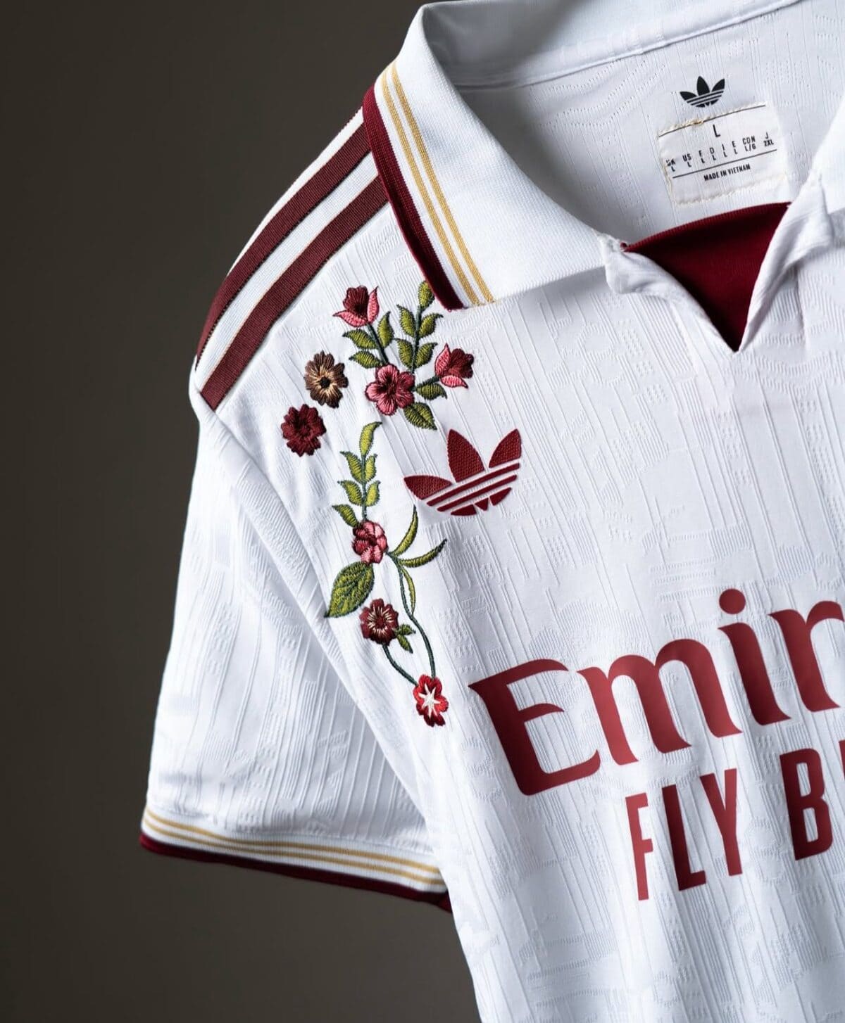 Real Madrid away jersey with floral embroidery and red and gold accents.