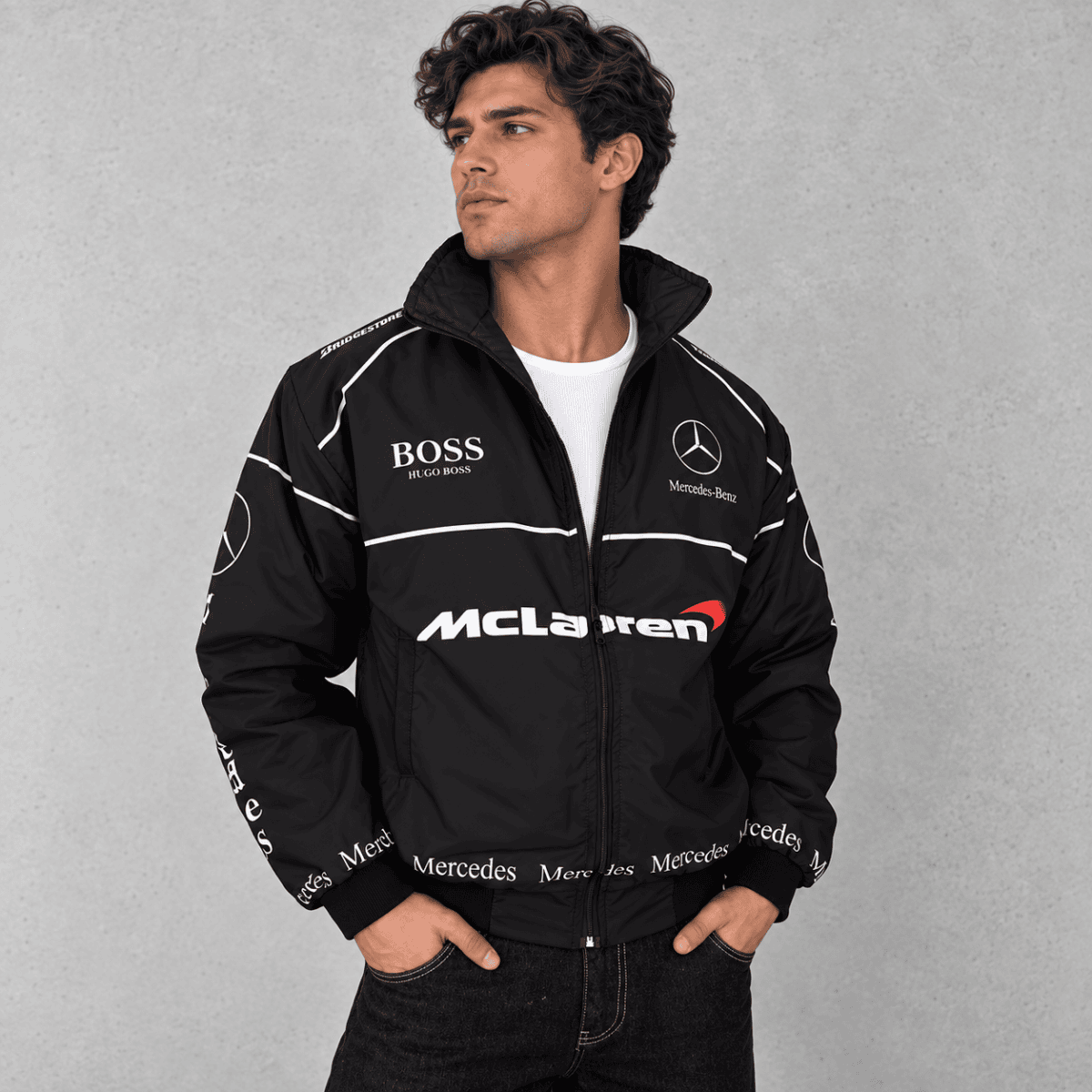 Black Mercedes-AMG Petronas Formula 1 team jacket with sponsor logos and white accents.