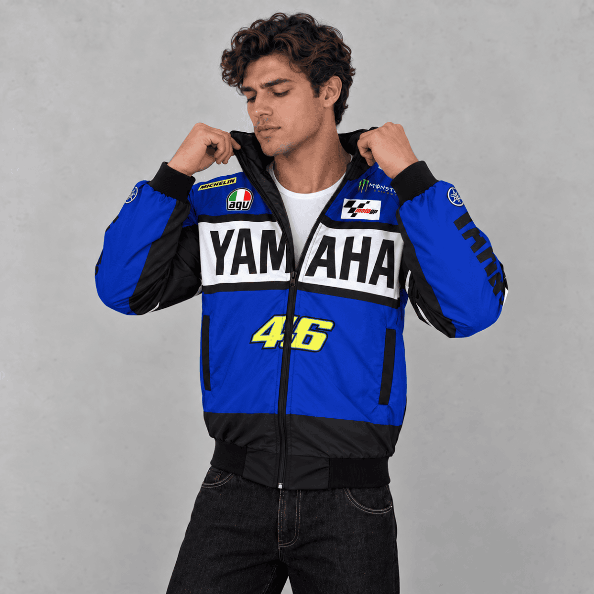 Man wearing Yamaha MotoGP team jacket in blue, black, and white colors.
