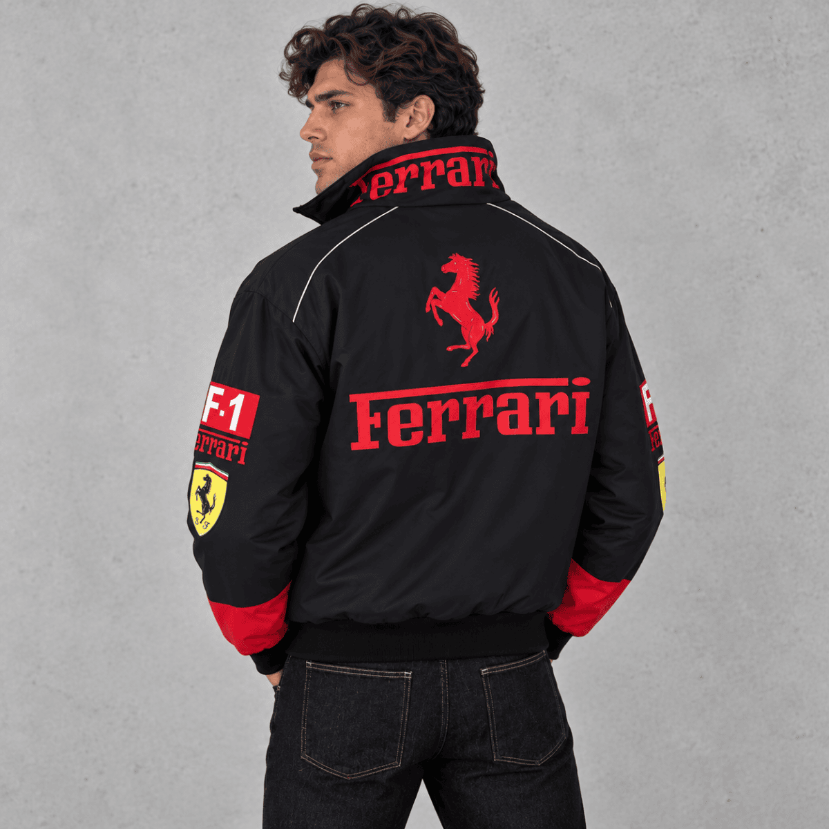 Black Ferrari racing jacket with red logo and sponsor patches on sleeves.