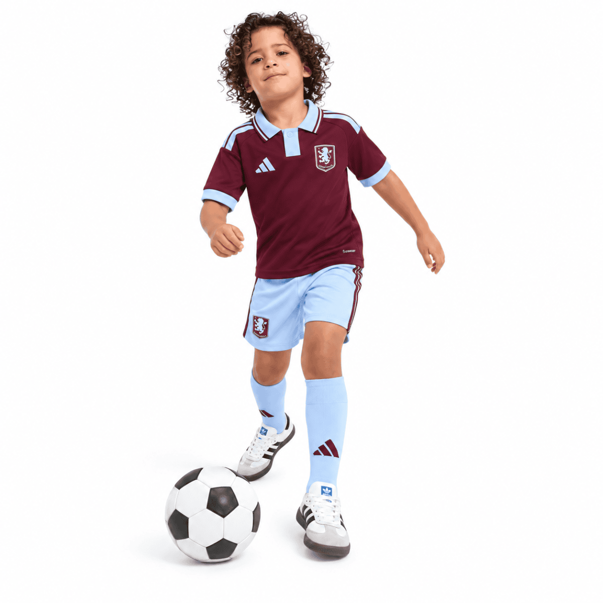 Child wearing Aston Villa home kids kit 2026/27 with maroon and sky blue colors.