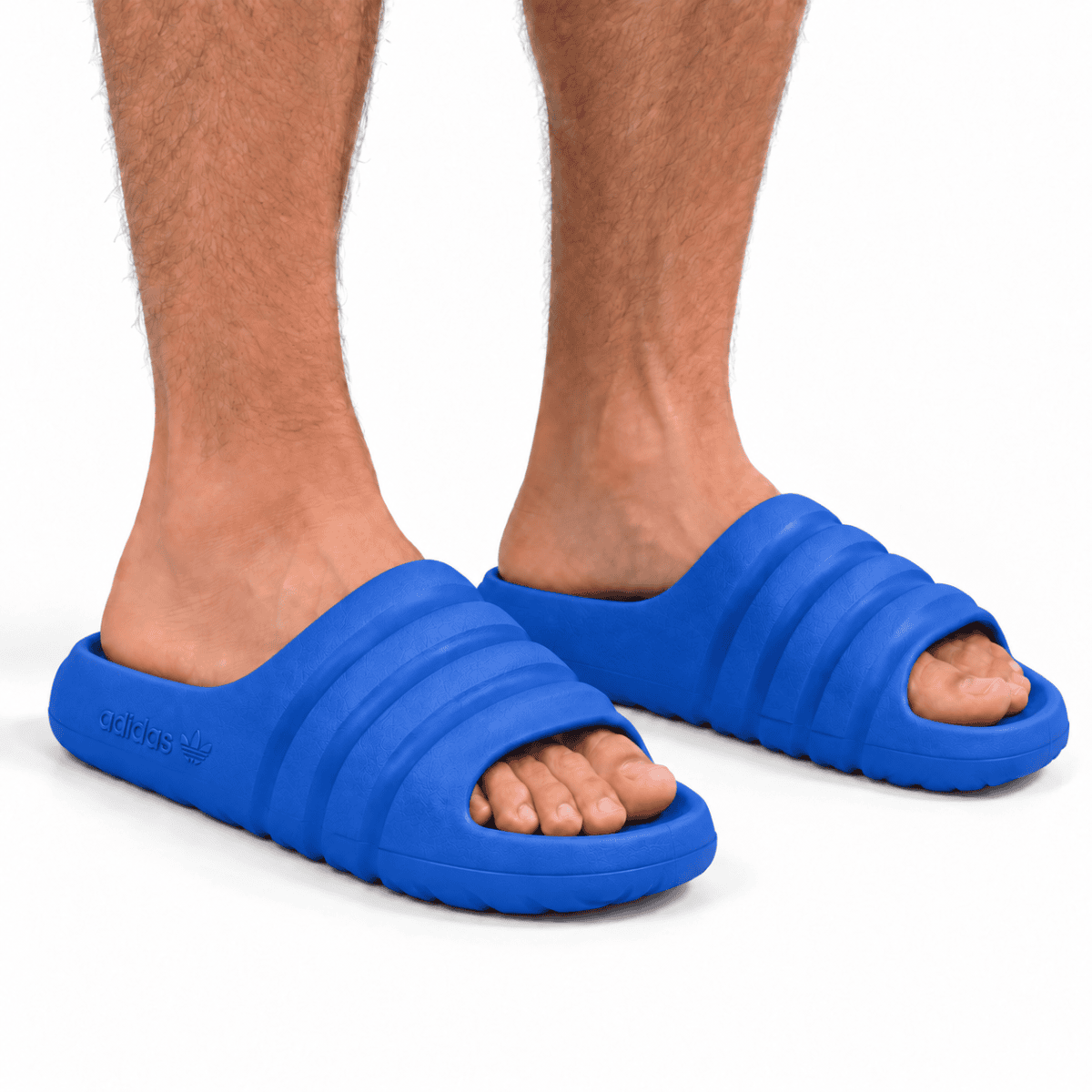 Blue Adidas Adilette Ayoon Slides x Bad Bunny on feet, casual footwear.