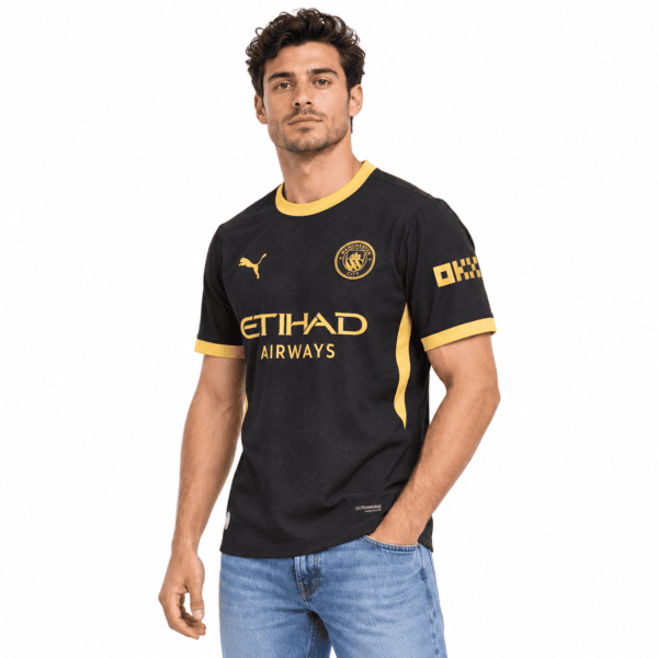 446979c0-1cc8-46fd-aa37-b2c375258738 - UAE SPORT STORE Man City away jersey 2026/27 black with yellow accents and club crest.