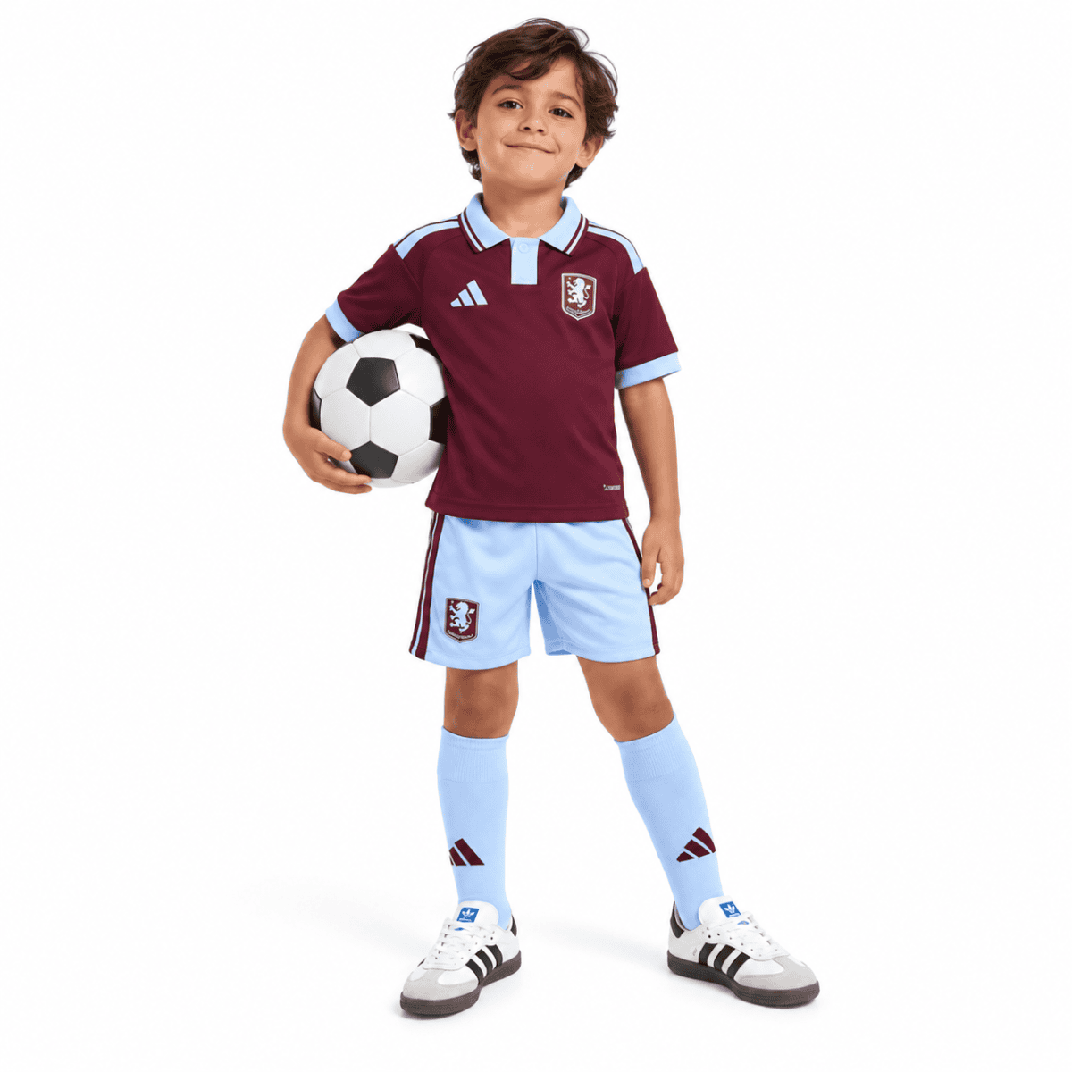 Child in Aston Villa home kids kit 2026/27 holding soccer ball.