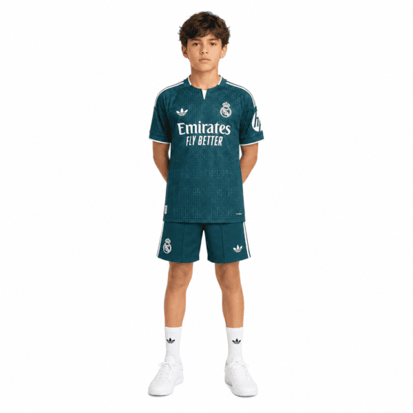 Real Madrid kids away kit 2026/27, teal jersey and shorts, white socks, front view.