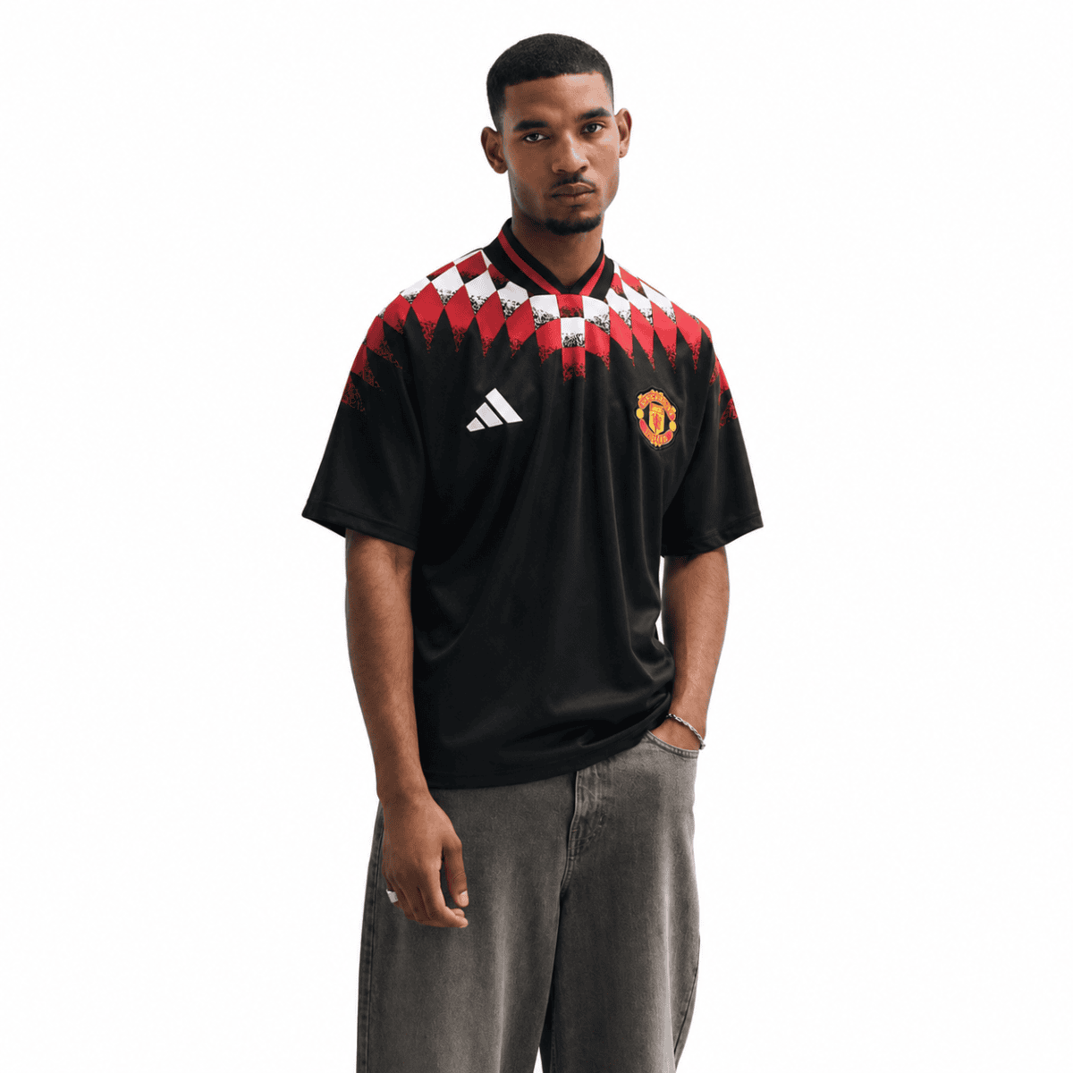 Manchester United lifestyle jersey with red, black, and white geometric pattern.